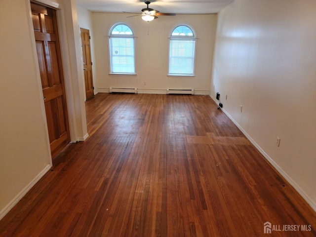 251 Henry St, South Amboy, NJ 08879 - spare room featuring baseboard heating, a ceiling fan, dark wood-style floors, and baseboards