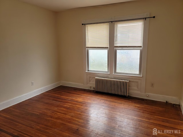 251 Henry St, South Amboy, NJ 08879 - empty room with radiator heating unit, wood-type flooring, and baseboards