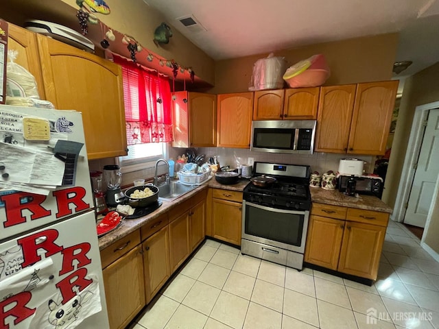 18 Bethany St, New Brunswick, NJ 08901 - kitchen featuring stainless steel appliances, a sink, light tile patterned flooring, and backsplash