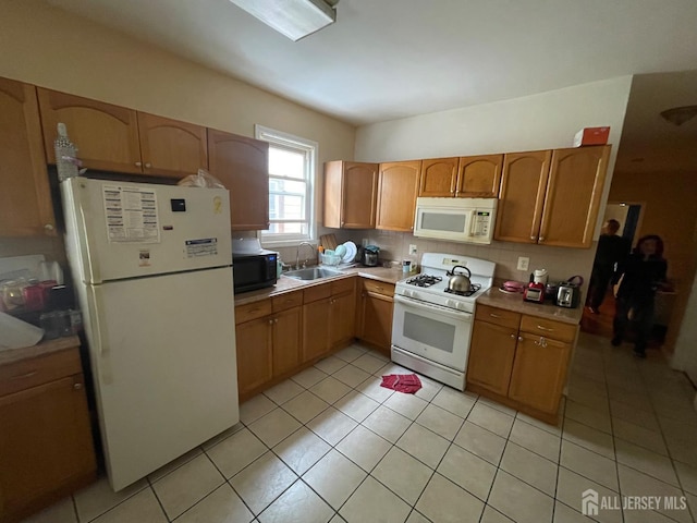 18 Bethany St, New Brunswick, NJ 08901 - kitchen featuring white appliances, a sink, light countertops, and light tile patterned floors