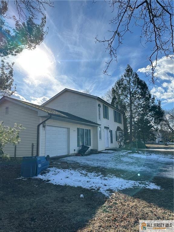 view of side of property with a garage