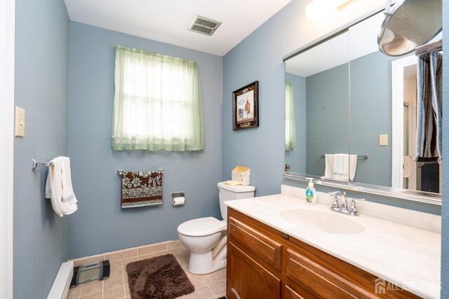 bathroom featuring vanity, toilet, and tile patterned flooring