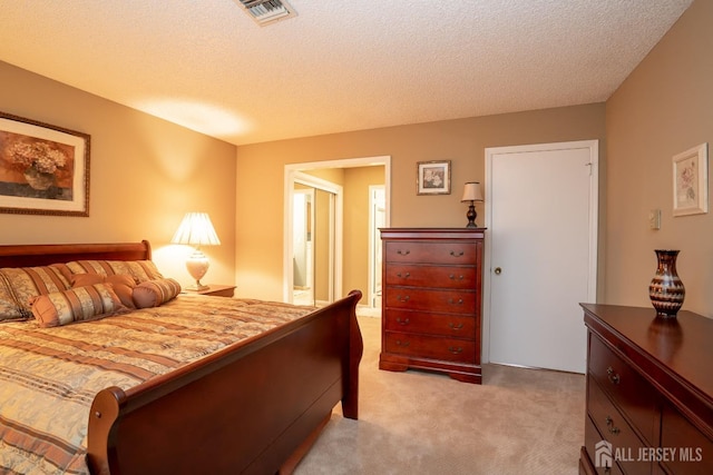 carpeted bedroom with a textured ceiling