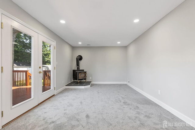 141 Day St, South Plainfield, NJ 07080 - unfurnished living room with french doors, carpet floors, recessed lighting, and a wood stove