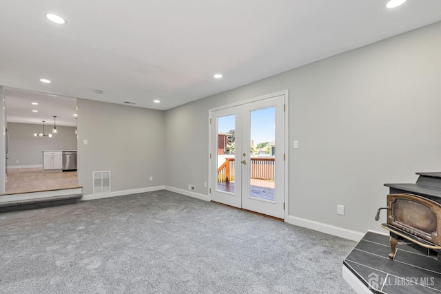 141 Day St, South Plainfield, NJ 07080 - unfurnished living room featuring a wood stove, french doors, carpet, baseboards, and recessed lighting
