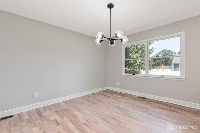141 Day St, South Plainfield, NJ 07080 - unfurnished room featuring baseboards, light wood-style floors, and a chandelier