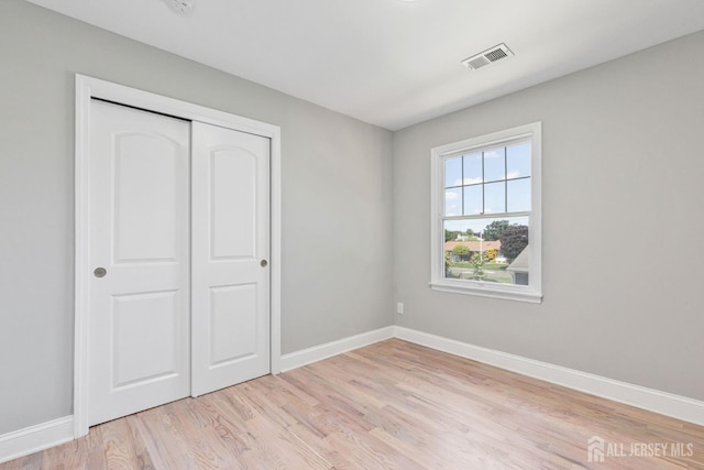 141 Day St, South Plainfield, NJ 07080 - unfurnished bedroom with baseboards, light wood finished floors, and a closet