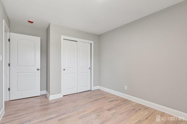 141 Day St, South Plainfield, NJ 07080 - unfurnished bedroom with baseboards, light wood-type flooring, and a closet