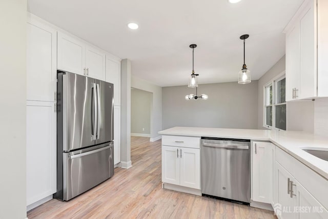 141 Day St, South Plainfield, NJ 07080 - kitchen with appliances with stainless steel finishes, a peninsula, white cabinetry, light countertops, and recessed lighting