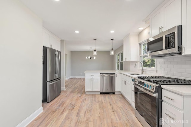 141 Day St, South Plainfield, NJ 07080 - kitchen with appliances with stainless steel finishes, a sink, a peninsula, decorative backsplash, and baseboards