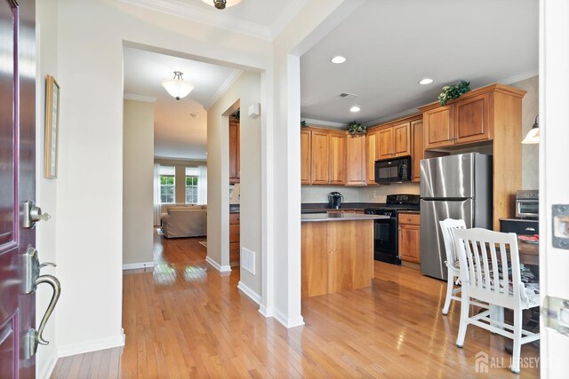 4 Sandra Ct Unit 2743, Old Bridge, NJ 08857 - kitchen with black appliances, crown molding, light wood finished floors, dark countertops, and baseboards