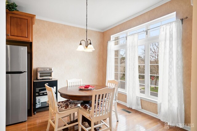 4 Sandra Ct Unit 2743, Old Bridge, NJ 08857 - dining room with light wood-style floors, plenty of natural light, a chandelier, baseboards, and ornamental molding
