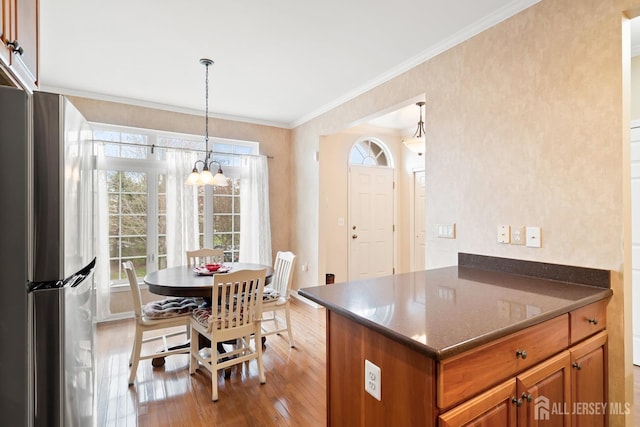 4 Sandra Ct Unit 2743, Old Bridge, NJ 08857 - kitchen featuring a chandelier, freestanding refrigerator, brown cabinetry, light wood-style floors, and crown molding