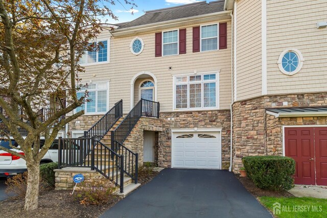 4 Sandra Ct Unit 2743, Old Bridge, NJ 08857 - view of property featuring stone siding, an attached garage, asphalt driveway, and stairs