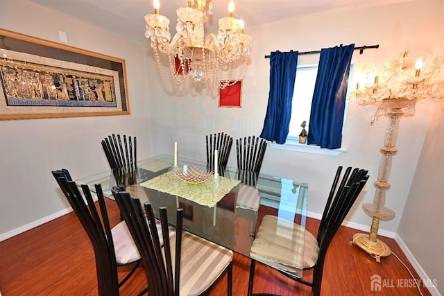 dining area with a chandelier, wood finished floors, and baseboards