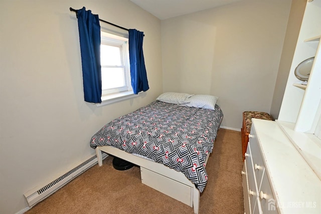carpeted bedroom featuring baseboard heating and baseboards