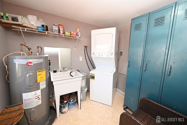 washroom with electric water heater and stacked washing machine and dryer