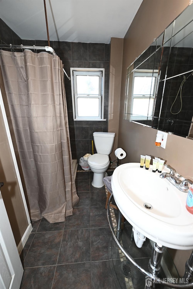 bathroom featuring toilet and a shower with shower curtain