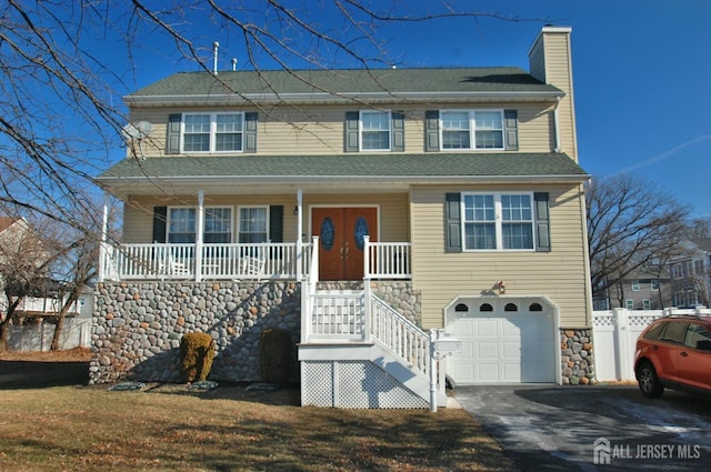 view of front of house with aphalt driveway, covered porch, a garage, fence, and a chimney