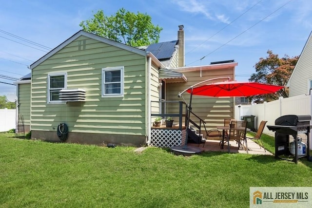1 Berkley Blvd, Iselin, NJ 08830 - rear view of house with a patio area and roof mounted solar panels