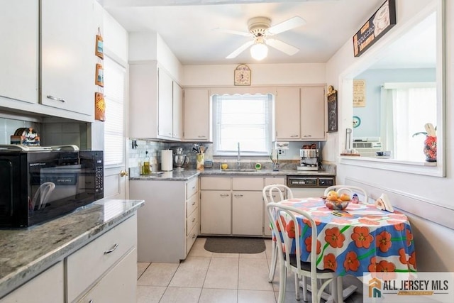 1 Berkley Blvd, Iselin, NJ 08830 - kitchen with black microwave, a sink, ceiling fan, light tile patterned flooring, and tasteful backsplash