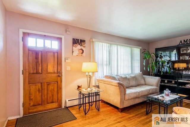 1 Berkley Blvd, Iselin, NJ 08830 - living area with healthy amount of natural light, light wood-style floors, and baseboard heating