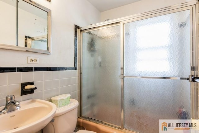 1 Berkley Blvd, Iselin, NJ 08830 - bathroom featuring a sink, tile walls, bath / shower combo with glass door, and toilet