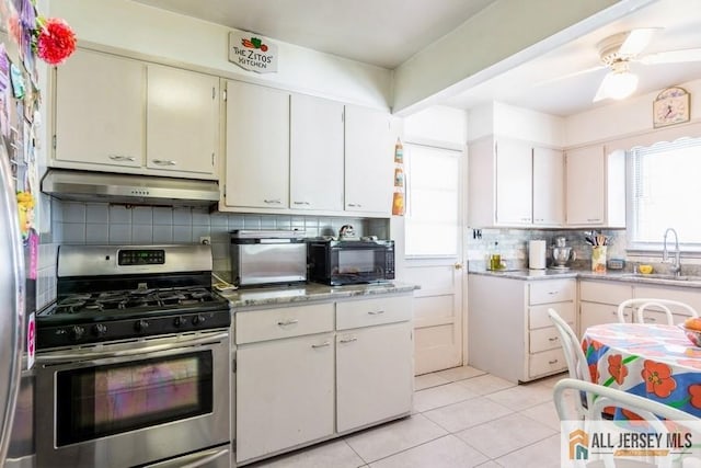 1 Berkley Blvd, Iselin, NJ 08830 - kitchen with gas stove, under cabinet range hood, a sink, and healthy amount of natural light