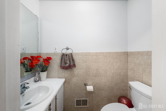 66 Riverbend Dr, North Brunswick, NJ 08902 - bathroom featuring tile walls, vanity, and a wainscoted wall