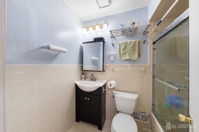 66 Riverbend Dr, North Brunswick, NJ 08902 - full bath featuring tile walls, vanity, shower / bath combination with glass door, and wainscoting