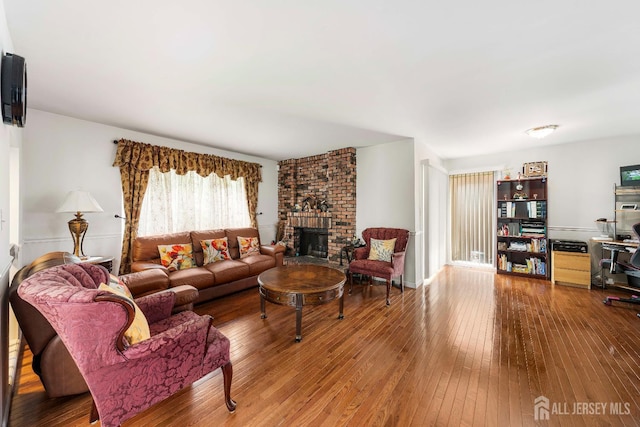 66 Riverbend Dr, North Brunswick, NJ 08902 - living area with wood-type flooring and a brick fireplace