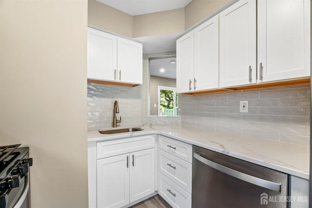 1018 Schmidt Ln, North Brunswick, NJ 08902 - kitchen with dishwasher, a sink, and white cabinets