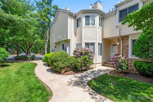 1018 Schmidt Ln, North Brunswick, NJ 08902 - view of front of property featuring a front yard and a chimney