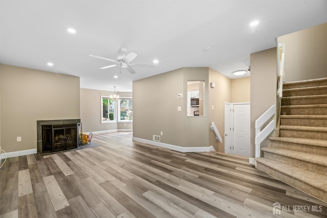 1018 Schmidt Ln, North Brunswick, NJ 08902 - unfurnished living room with recessed lighting, ceiling fan, wood finished floors, baseboards, and stairs