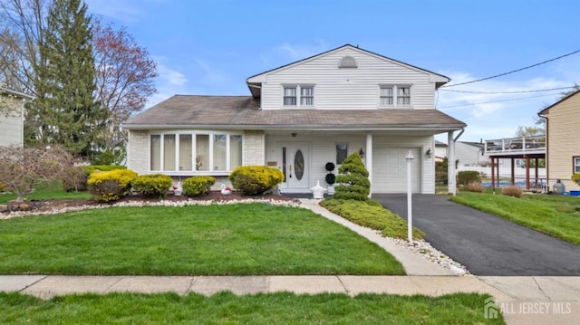 3 Hansen Rd, Old Bridge, NJ 08857 - traditional-style house featuring an attached garage, a front yard, and asphalt driveway