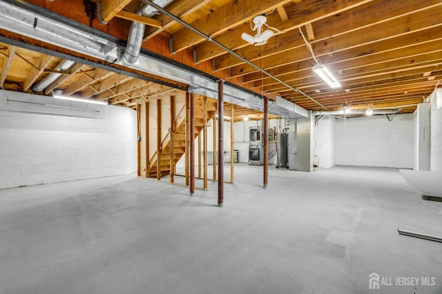 unfinished basement with stairs and water heater