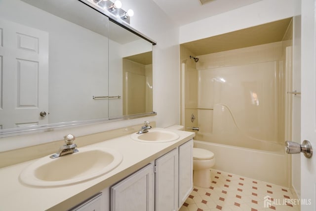 bathroom with a sink, shower / bathing tub combination, toilet, and double vanity