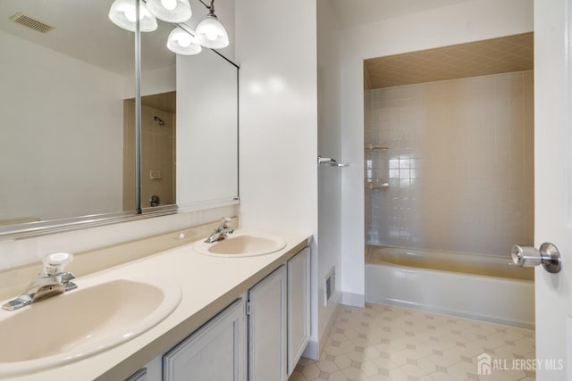 full bathroom featuring double vanity, bathing tub / shower combination, visible vents, and a sink