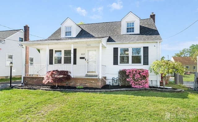 553 Harrison Ave, South Plainfield, NJ 07080 - view of front of house featuring a front lawn, covered porch, a shingled roof, and a chimney