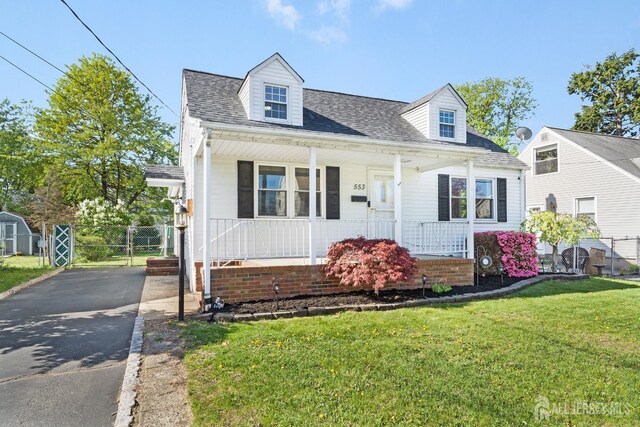 cape cod home featuring a front lawn, fence, a shingled roof, a porch, and driveway