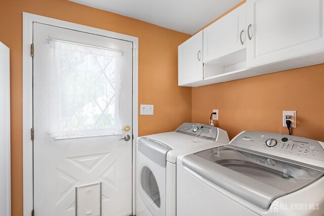 washroom with cabinet space and washer and dryer