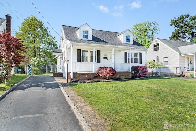 553 Harrison Ave, South Plainfield, NJ 07080 - cape cod-style house featuring a porch, a shingled roof, and asphalt driveway