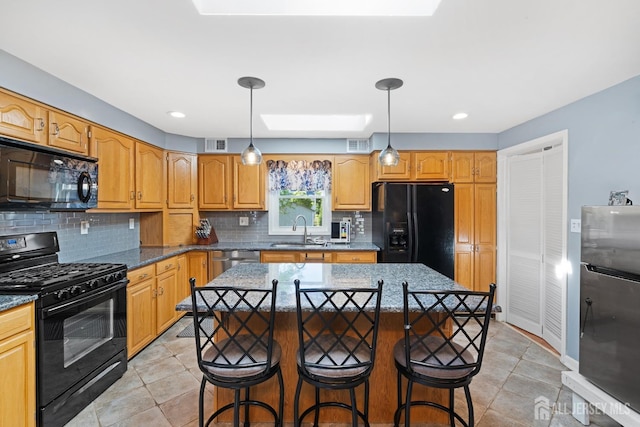 553 Harrison Ave, South Plainfield, NJ 07080 - kitchen featuring black appliances, a sink, tasteful backsplash, a kitchen breakfast bar, and a center island