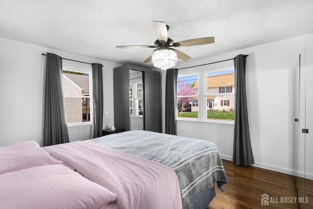 553 Harrison Ave, South Plainfield, NJ 07080 - bedroom with wood finished floors, multiple windows, baseboards, and a ceiling fan