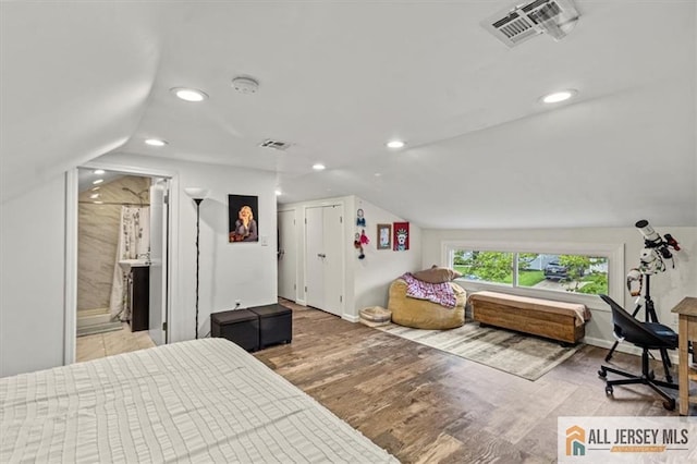 60 Sycamore St, Carteret, NJ 07008 - bedroom with vaulted ceiling, recessed lighting, wood finished floors, and connected bathroom