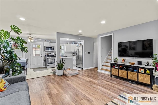 60 Sycamore St, Carteret, NJ 07008 - living room featuring stairway, light wood-style flooring, a ceiling fan, and recessed lighting