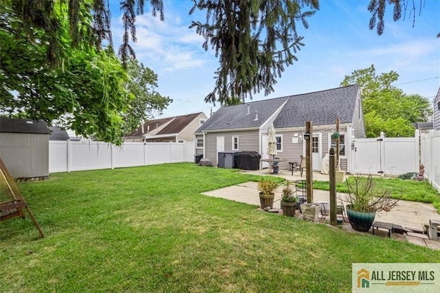 60 Sycamore St, Carteret, NJ 07008 - back of house featuring a patio area, a fenced backyard, roof with shingles, and a storage shed