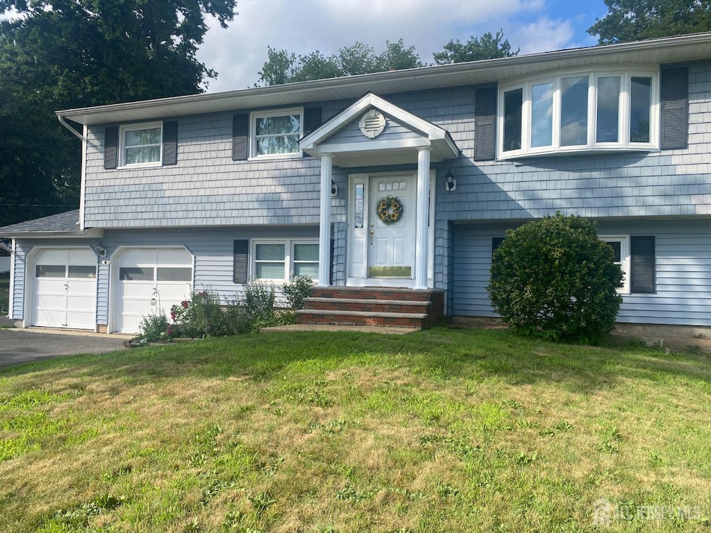 1461 Fela Ave, North Brunswick, NJ 08902 - split foyer home with driveway, a garage, and a front yard