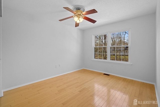 18 Albury Way N, Brunswick, NJ 08902 - spare room featuring baseboards, light wood-type flooring, a ceiling fan, and a textured ceiling