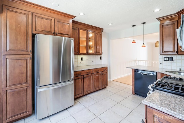 18 Albury Way N, Brunswick, NJ 08902 - kitchen with freestanding refrigerator, dishwasher, decorative backsplash, brown cabinetry, and recessed lighting
